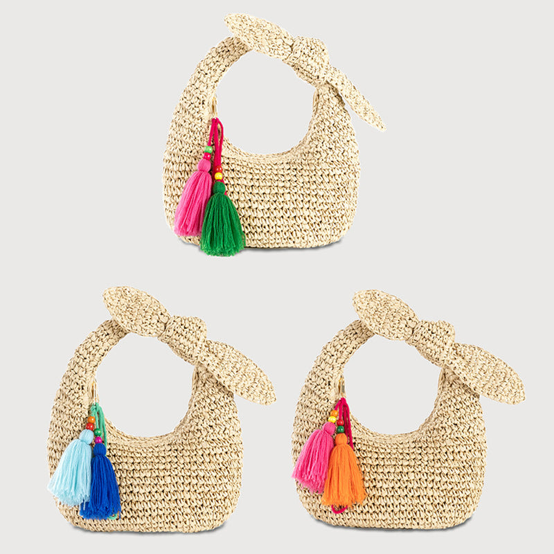 straw bag with bow detail and colorful tassels
