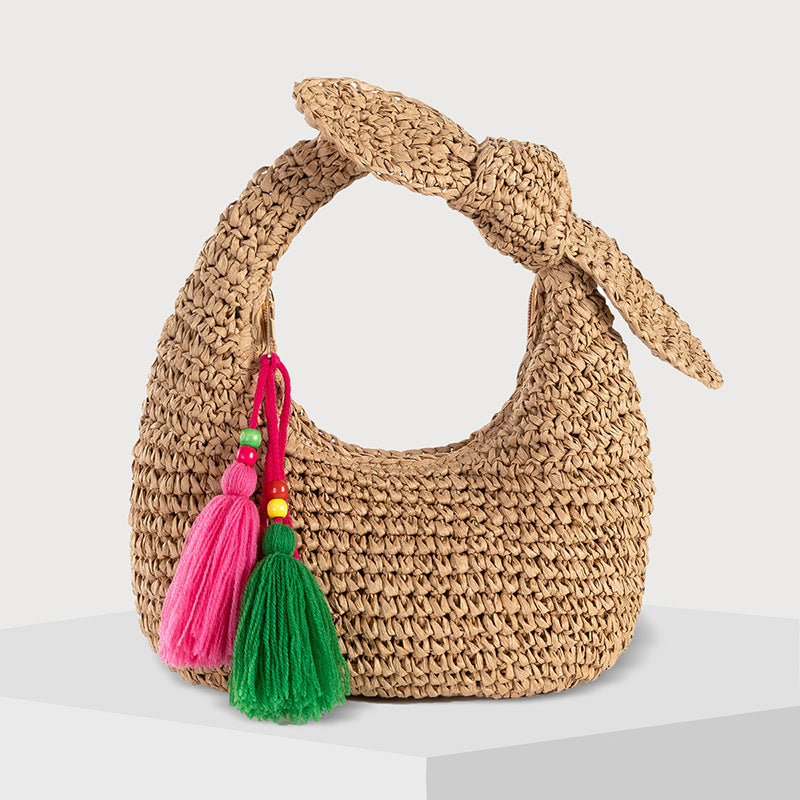 straw bag with bow detail and colorful tassels