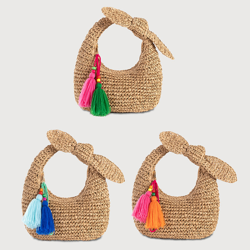 straw bag with bow detail and colorful tassels
