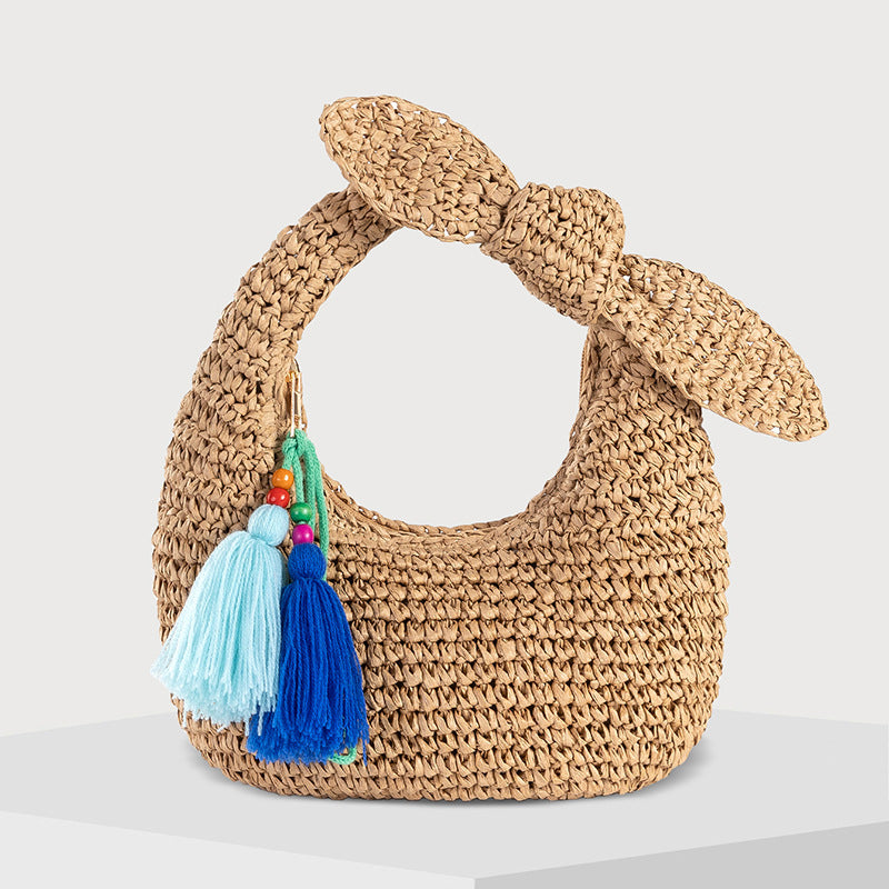 straw bag with bow detail and colorful tassels
