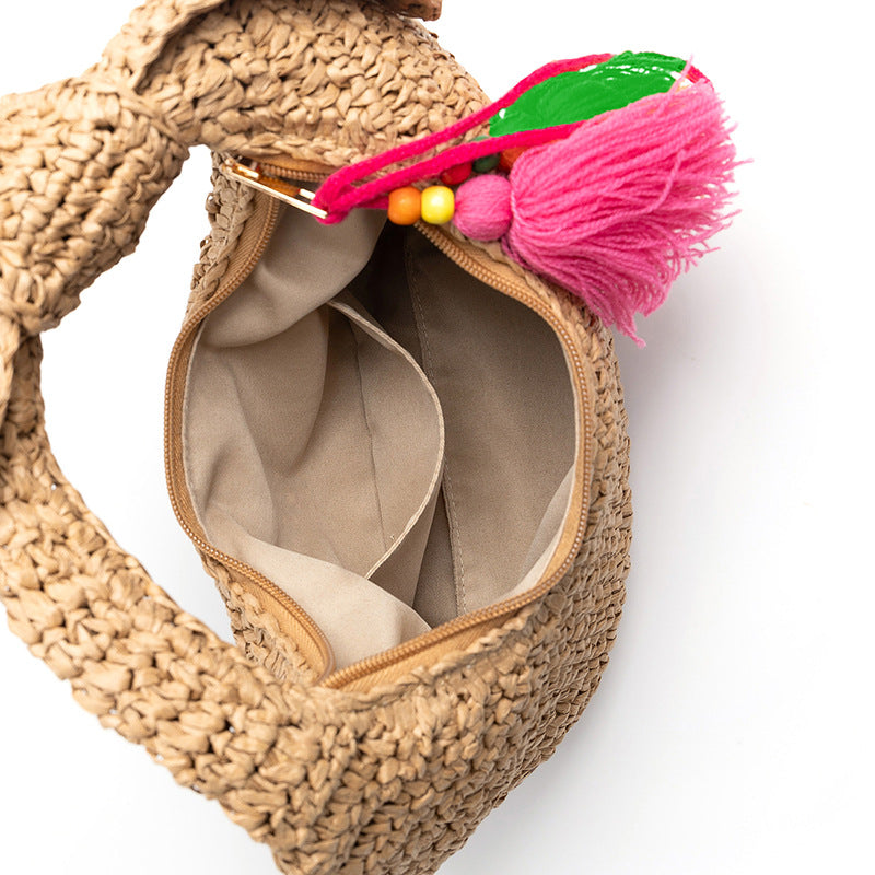 straw bag with bow detail and colorful tassels