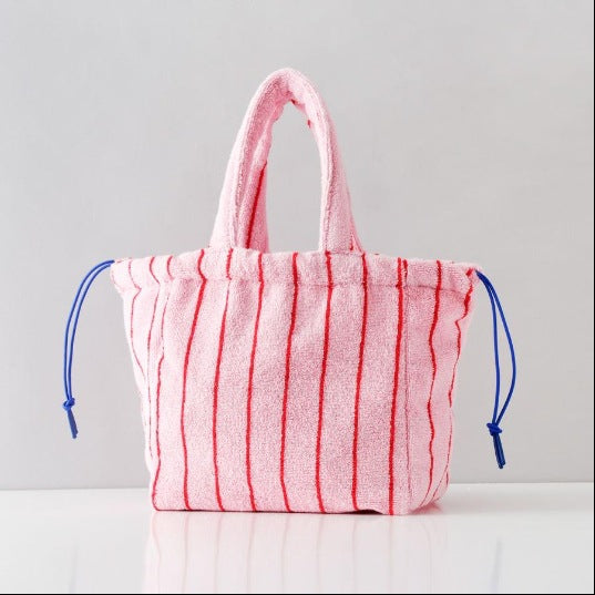 A multi-color striped terry cloth bag with drawstring