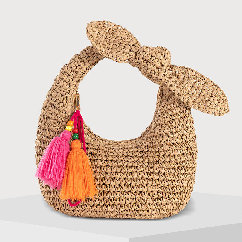 straw bag with bow detail and colorful tassels