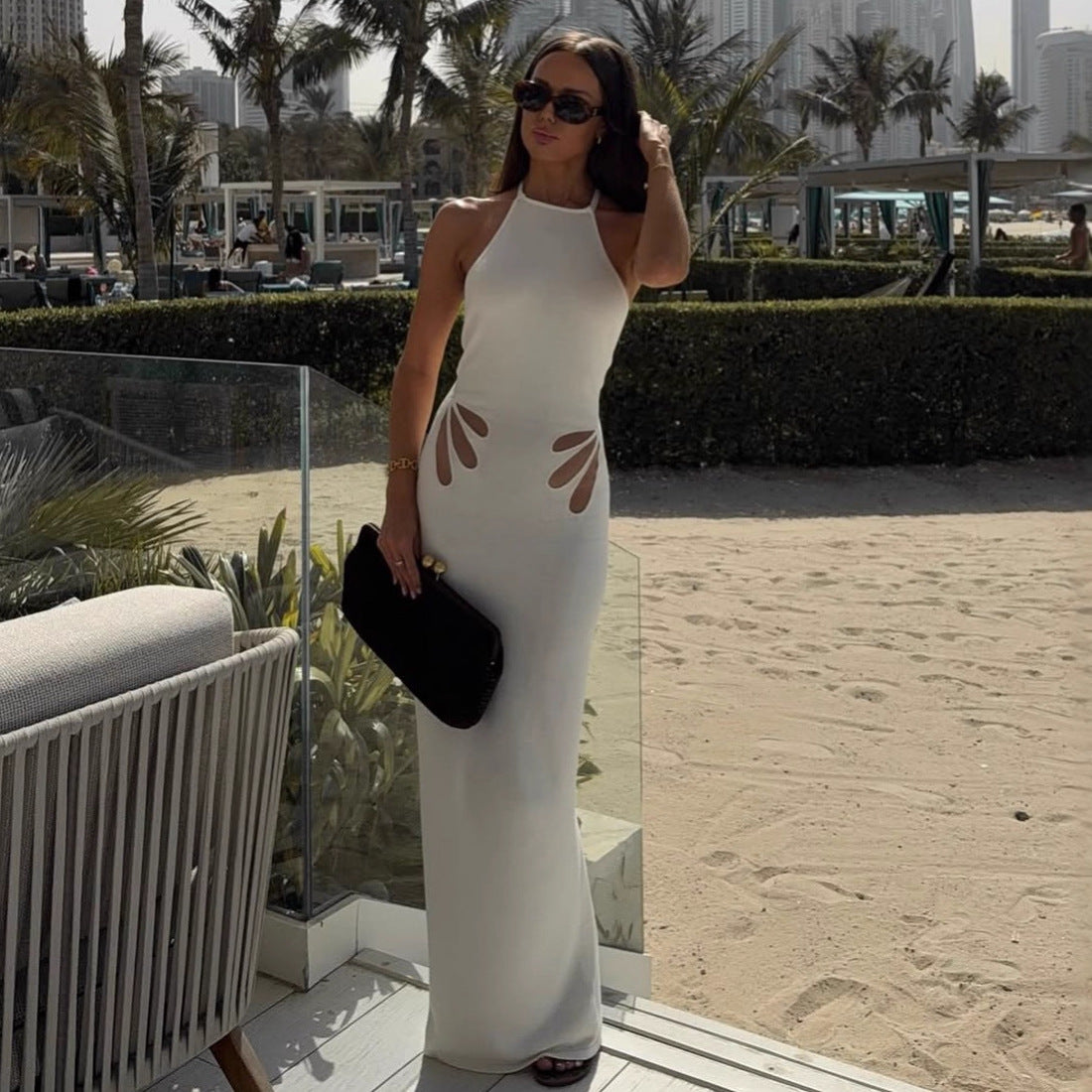 Women's figure-hugging, halter-neck dress with cut outs